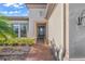 Home's entry featuring brick path, neutral paint, and decorative potted plants at 4109 Cascina Way, Sarasota, FL 34238