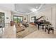 Bright living room with tile floors, tray ceiling, and comfortable seating at 4109 Cascina Way, Sarasota, FL 34238