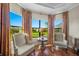 Charming sitting area with beautiful view of the yard and curtains to match at 4109 Cascina Way, Sarasota, FL 34238