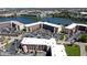 An aerial view of the condo community with multiple buildings, parking, and a waterfront view of the lake at 4133 Heron Way # E202, Bradenton, FL 34205