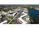 A high-angle view of the condos, pool, lake, and surrounding neighborhood, showcasing the community's location at 4133 Heron Way # E202, Bradenton, FL 34205