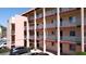A view of a balcony with metal railings in a multi-story building with parked cars nearby at 4133 Heron Way # E202, Bradenton, FL 34205