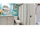 Stylish bathroom features a patterned shower curtain, modern vanity, and coordinated decor at 4133 Heron Way # E202, Bradenton, FL 34205