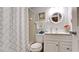 Bathroom featuring white fixtures, patterned shower curtain, and tiled walls at 4133 Heron Way # E202, Bradenton, FL 34205