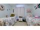 Comfortable bedroom with twin beds and floral bedding at 4133 Heron Way # E202, Bradenton, FL 34205