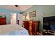 A calming bedroom with wood furniture, leading to a bathroom, offers a cozy retreat at 4133 Heron Way # E202, Bradenton, FL 34205
