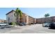 Multi-story condo complex with ample parking and lush landscaping on a sunny day at 4133 Heron Way # E202, Bradenton, FL 34205