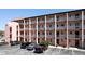 Exterior of condo building with parking and balconies at 4133 Heron Way # E202, Bradenton, FL 34205