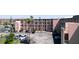 Full exterior view of the condo building showing balconies and ample parking at 4133 Heron Way # E202, Bradenton, FL 34205