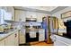 Bright kitchen featuring updated cabinets, stainless steel appliances, and modern fixtures at 4133 Heron Way # E202, Bradenton, FL 34205