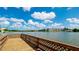 Scenic view from the dock overlooking a serene lake and waterfront condos at 4133 Heron Way # E202, Bradenton, FL 34205