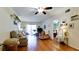 Cozy living room with ceiling fan, wood floors, and access to outdoor patio at 4133 Heron Way # E202, Bradenton, FL 34205