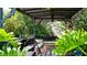 Shaded patio featuring outdoor seating with lush greenery surrounding the relaxing space at 4133 Heron Way # E202, Bradenton, FL 34205
