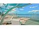 Peaceful waterfront view featuring shaded seating areas, ideal for enjoying the tranquil scenery and beautiful weather at 4133 Heron Way # E202, Bradenton, FL 34205