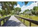 Picturesque community bridge surrounded by lush greenery and leading to a park with a gazebo and picnic area at 4149 Salernes Ave # 3048, Sarasota, FL 34233