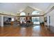 Club house interior featuring a fireplace, American flag, and serene pool views through floor to ceiling windows at 4149 Salernes Ave # 3048, Sarasota, FL 34233