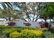 Beautifully landscaped community entrance with colorful plants and a welcoming sign: Casa del Sol at 4149 Salernes Ave # 3048, Sarasota, FL 34233