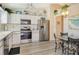 Bright kitchen features stainless steel appliances, white cabinets, and a dining table at 4149 Salernes Ave # 3048, Sarasota, FL 34233