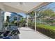 Inviting screened lanai with a lovely view of the lush landscaping and tranquil lake at 4149 Salernes Ave # 3048, Sarasota, FL 34233