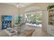 Bright and airy living room with an expansive glass window offering scenic views of the outdoor patio and pond at 4149 Salernes Ave # 3048, Sarasota, FL 34233