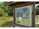 View the details of Urfer Gathering Park displayed on a large sign, showcasing trails, lakes and other amenities at 4149 Salernes Ave # 3048, Sarasota, FL 34233