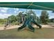 Community playground featuring slides, climbing structures, and a shaded area for fun and recreation at 4149 Salernes Ave # 3048, Sarasota, FL 34233
