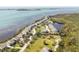 Panoramic aerial view of waterfront homes, showcasing lush landscaping and beautiful coastal scenery at 44 Tidy Island Blvd, Bradenton, FL 34210