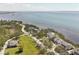 Aerial view of elegant waterfront homes with private access to bay waters and beautifully maintained lawns at 44 Tidy Island Blvd, Bradenton, FL 34210