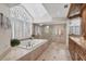 Elegant bathroom with soaking tub, glass shower, dual sinks, and natural light from the window at 44 Tidy Island Blvd, Bradenton, FL 34210