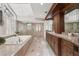 Luxury bathroom featuring dual sinks, a soaking tub, and a glass-enclosed shower at 44 Tidy Island Blvd, Bradenton, FL 34210