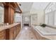 A bright bathroom with a jacuzzi tub, double vanity, and stained-glass window at 44 Tidy Island Blvd, Bradenton, FL 34210