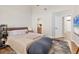 A neutral bedroom boasts a soft rug, vaulted ceilings, and access to the bathroom at 44 Tidy Island Blvd, Bradenton, FL 34210