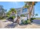 Inviting coastal home showcasing a brick stairway and lush landscaping at 44 Tidy Island Blvd, Bradenton, FL 34210