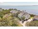 Waterfront home featuring meticulous landscaping, a brick driveway, and stunning views of the bay waters at 44 Tidy Island Blvd, Bradenton, FL 34210