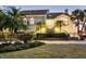 Elegant, multi-story home surrounded by lush landscaping, showcasing its architectural details and curb appeal at 44 Tidy Island Blvd, Bradenton, FL 34210