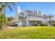 Charming stilt home boasts a large screened porch and a two-car garage at 44 Tidy Island Blvd, Bradenton, FL 34210