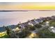 Scenic twilight view of waterfront homes nestled on a picturesque shoreline with lush trees and manicured landscapes at 44 Tidy Island Blvd, Bradenton, FL 34210