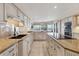 Bright kitchen boasts granite counters, large island with cooktop, and double oven and views of the water at 44 Tidy Island Blvd, Bradenton, FL 34210