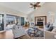 Bright living room with vaulted ceiling, fireplace, hardwood floors, and sliding glass doors to screened lanai at 44 Tidy Island Blvd, Bradenton, FL 34210