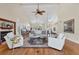 Spacious open-plan living room featuring a fireplace, high ceiling, skylight, and hardwood flooring at 44 Tidy Island Blvd, Bradenton, FL 34210