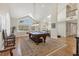 Bright living room featuring a pool table and large windows at 44 Tidy Island Blvd, Bradenton, FL 34210