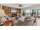 Bright living room featuring a fireplace, custom built-ins, and beautiful water views from sliding glass doors at 44 Tidy Island Blvd, Bradenton, FL 34210