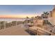 Outdoor seating area showcasing serene waterfront views and comfortable patio furniture at sunset at 44 Tidy Island Blvd, Bradenton, FL 34210