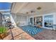 Covered brick patio provides stunning outdoor entertaining space with barbeque, fan, and views at 44 Tidy Island Blvd, Bradenton, FL 34210
