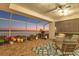 Cozy screened porch featuring comfortable seating, a ceiling fan, and scenic waterfront views at sunset at 44 Tidy Island Blvd, Bradenton, FL 34210