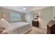 Cozy bedroom with a ceiling fan, shuttered window, dresser, and mirror create a relaxing space at 4486 Deer Creek Blvd, Sarasota, FL 34238