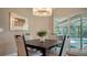 This dining area features a modern light fixture and sliding glass doors to the pool area at 4486 Deer Creek Blvd, Sarasota, FL 34238