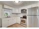 Bright kitchen featuring stainless steel appliances and white cabinetry at 452 Patterson Ave, Osprey, FL 34229