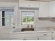 White cabinetry surrounds the sink, which is located in the kitchen at 452 Patterson Ave, Osprey, FL 34229