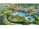 Aerial view of a resort-style pool area surrounded by lush landscaping, lounge chairs, and community amenities at 4617 Alexandria Ct, Palmetto, FL 34221